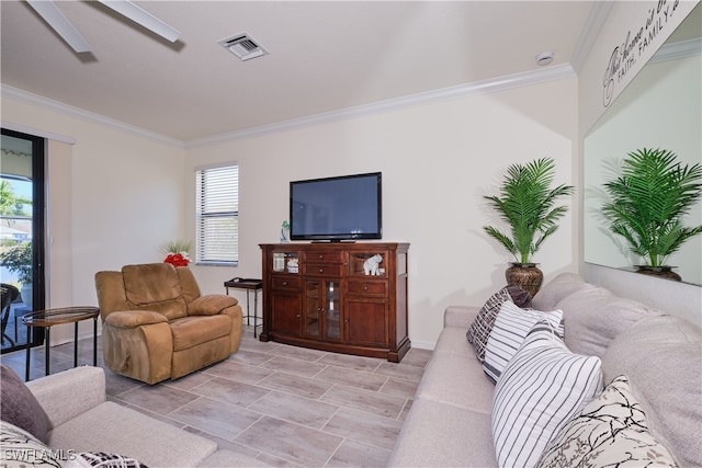 living room featuring ceiling fan and ornamental molding