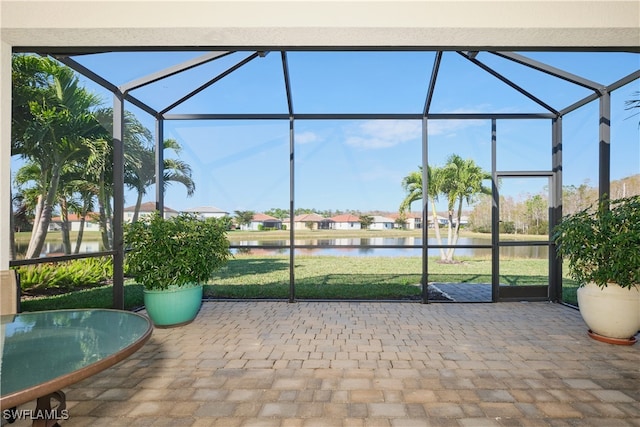 unfurnished sunroom with a water view