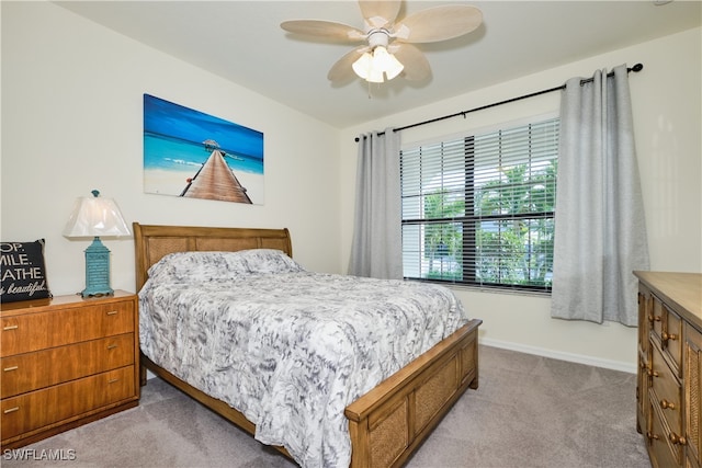 bedroom with light carpet and ceiling fan