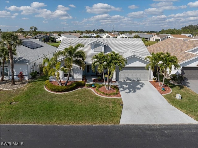 view of front of house featuring a garage and a front lawn