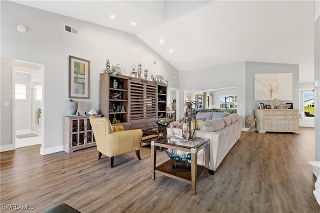 living room featuring hardwood / wood-style flooring and high vaulted ceiling