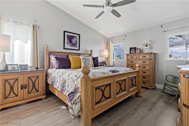 bedroom featuring dark wood-type flooring, ceiling fan, and lofted ceiling