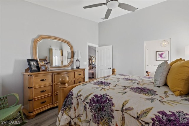 bedroom with dark hardwood / wood-style flooring and ceiling fan