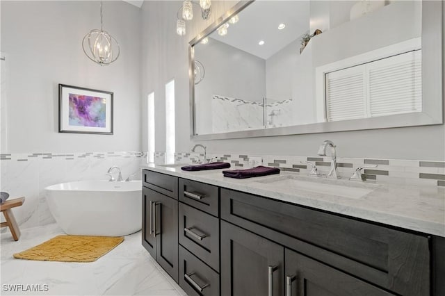 bathroom with vanity, a bath, and vaulted ceiling