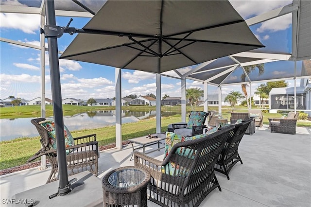 view of patio / terrace featuring a water view, a lanai, and an outdoor hangout area