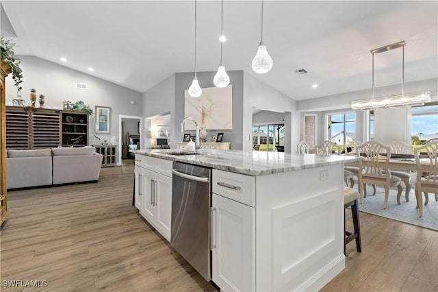 kitchen featuring sink, white cabinetry, light stone counters, dishwasher, and pendant lighting