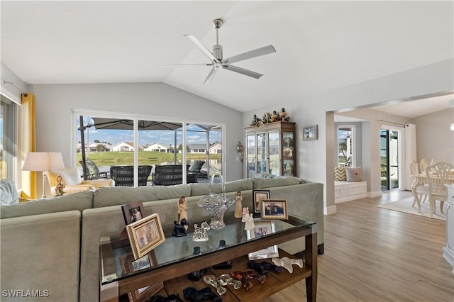 dining area with lofted ceiling, ceiling fan, and light wood-type flooring