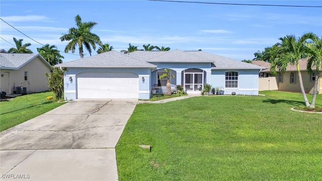 single story home with cooling unit, a garage, and a front lawn