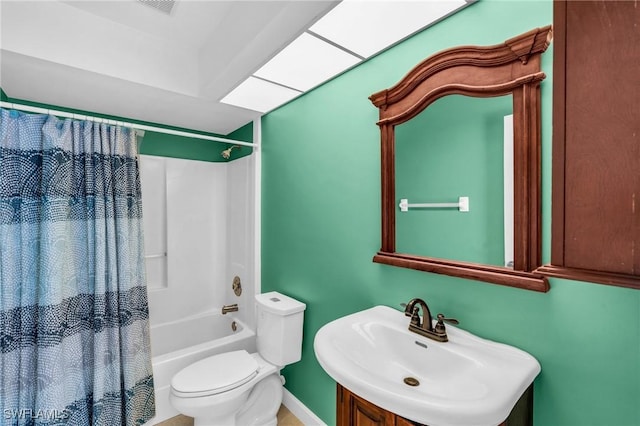 full bathroom featuring a skylight, sink, shower / bath combination with curtain, and toilet