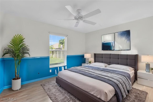 bedroom with ceiling fan and light hardwood / wood-style flooring