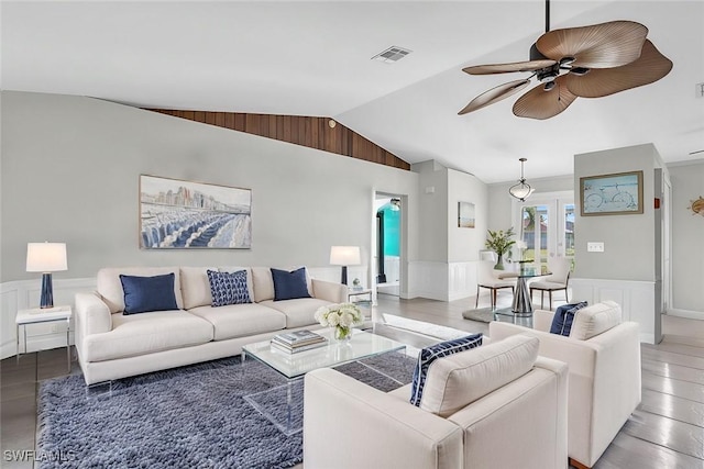 living room featuring vaulted ceiling and ceiling fan