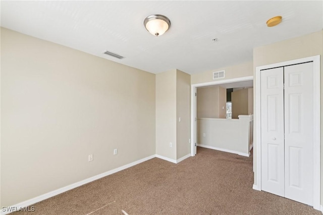 unfurnished bedroom featuring carpet flooring and a closet