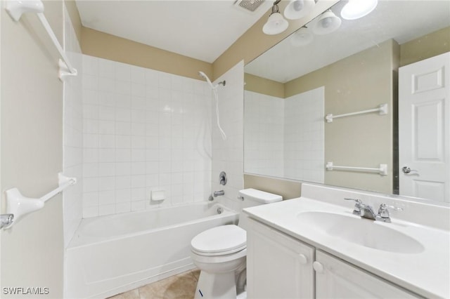 full bathroom with vanity, tiled shower / bath, tile patterned floors, and toilet