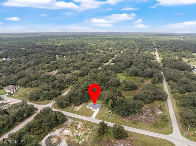 birds eye view of property featuring a wooded view