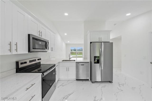 kitchen with light stone counters, recessed lighting, appliances with stainless steel finishes, white cabinetry, and a sink