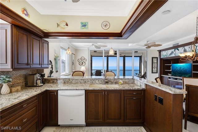 kitchen featuring pendant lighting, dishwasher, sink, ceiling fan, and kitchen peninsula