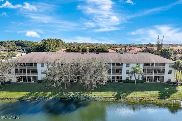 exterior space featuring a yard and a water view