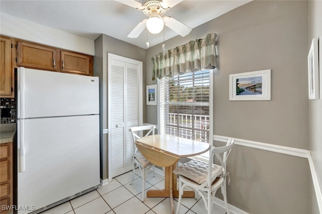 kitchen with white refrigerator, light tile patterned floors, and ceiling fan