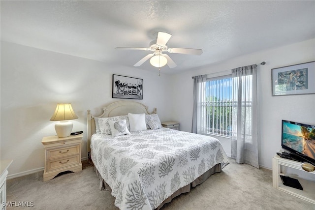 bedroom featuring light colored carpet and ceiling fan