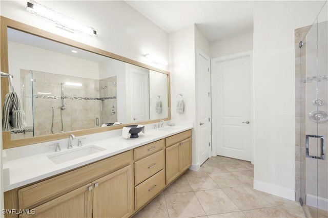 bathroom with a shower with door, vanity, and tile patterned flooring