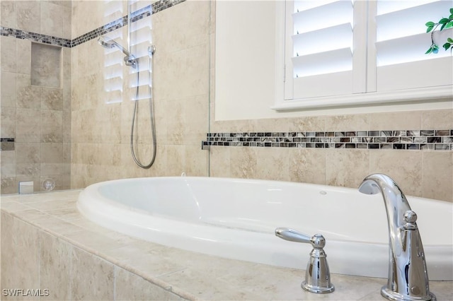 bathroom featuring tiled bath