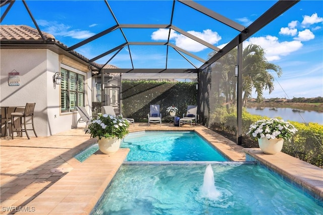 view of swimming pool featuring a patio area, glass enclosure, and a water view