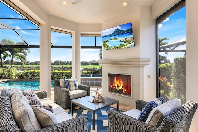 sunroom with a fireplace and a wealth of natural light