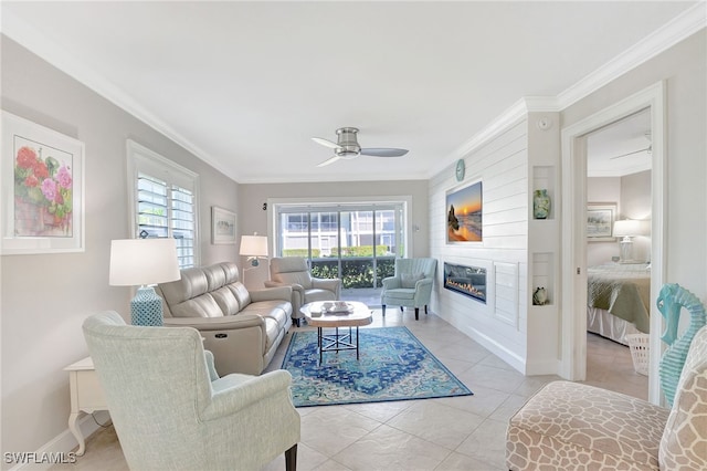 living room with ceiling fan, ornamental molding, and light tile patterned floors