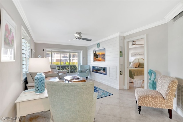 living room featuring ornamental molding, ceiling fan, and light tile patterned flooring