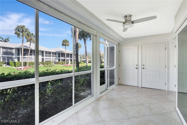 unfurnished sunroom featuring ceiling fan