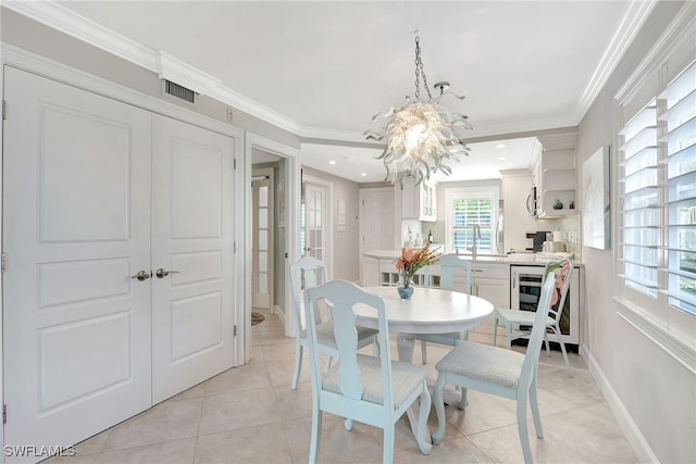 dining space with ornamental molding, sink, light tile patterned floors, and wine cooler