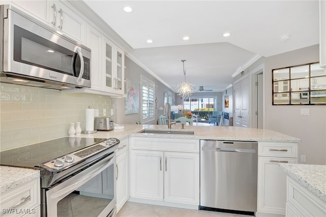 kitchen featuring pendant lighting, sink, white cabinets, stainless steel appliances, and crown molding