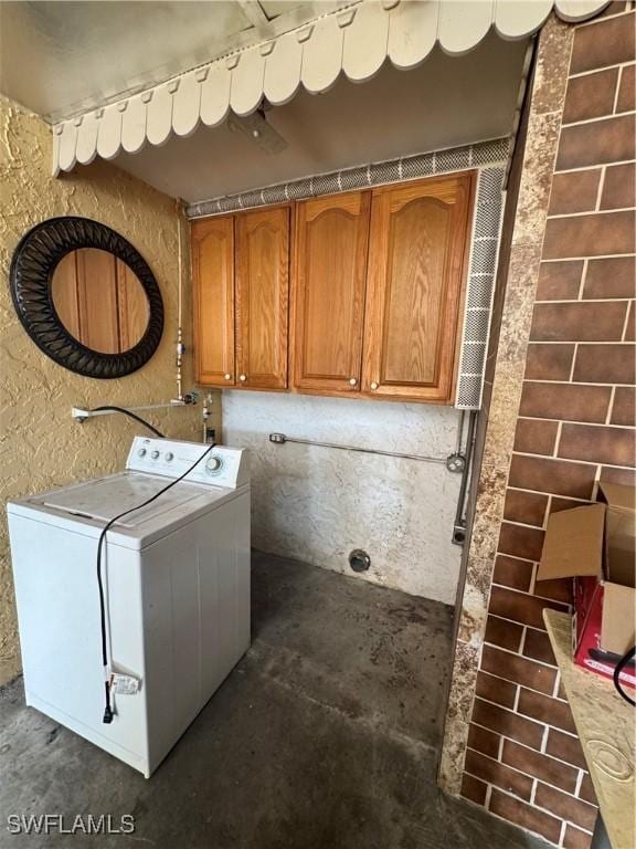 laundry area featuring cabinets