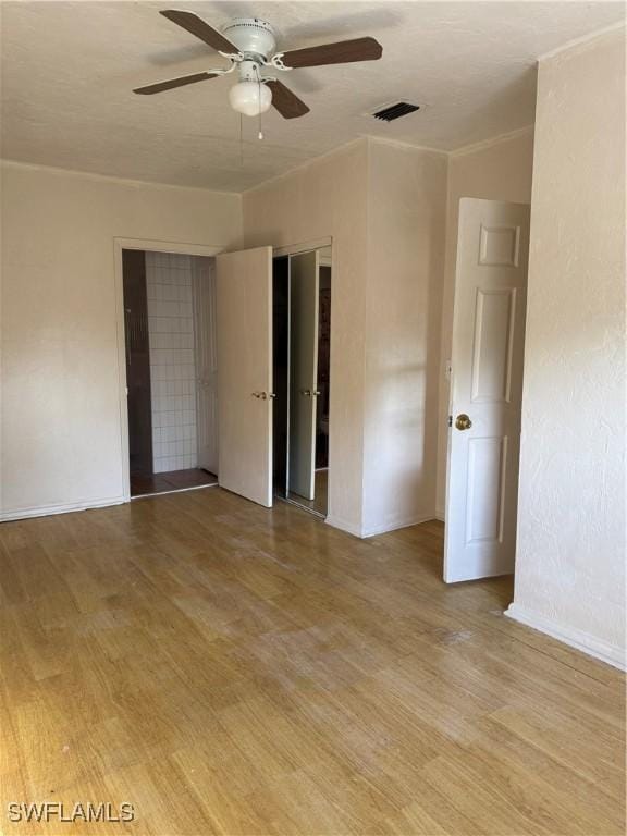 unfurnished room with ceiling fan and light wood-type flooring