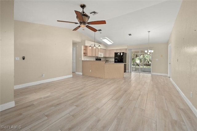 unfurnished living room with lofted ceiling, ceiling fan with notable chandelier, and light hardwood / wood-style flooring