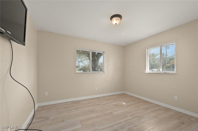 unfurnished room with light hardwood / wood-style flooring