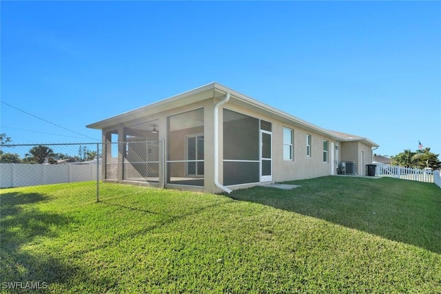 back of house featuring a yard and a sunroom