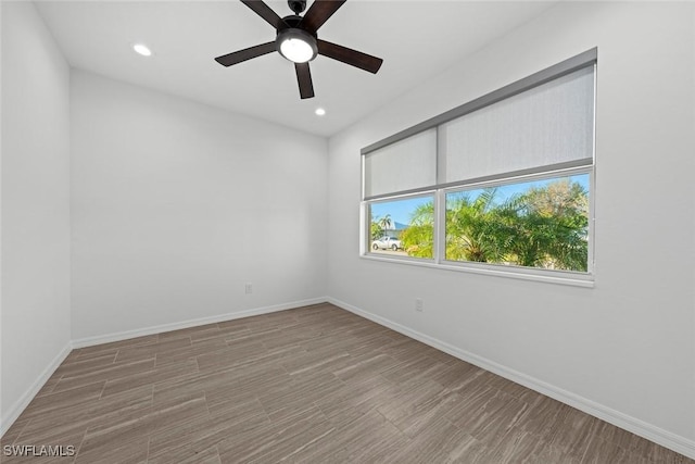 empty room with hardwood / wood-style floors and ceiling fan