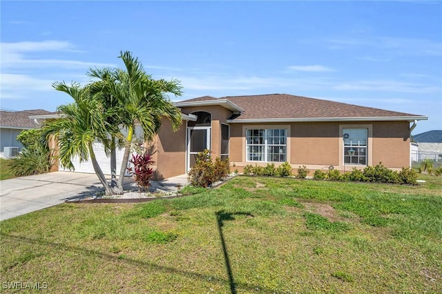 ranch-style home with a garage and a front lawn