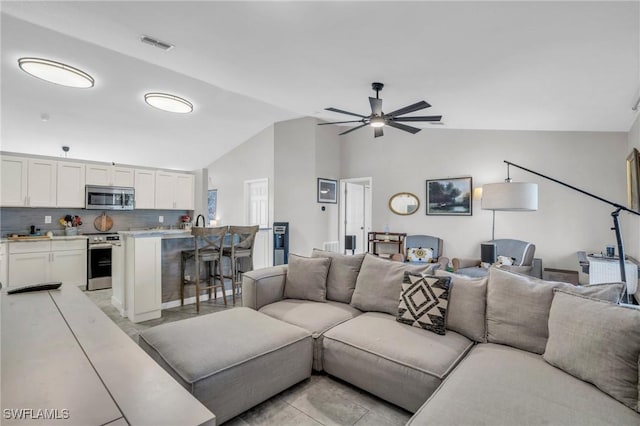 living room with vaulted ceiling and ceiling fan