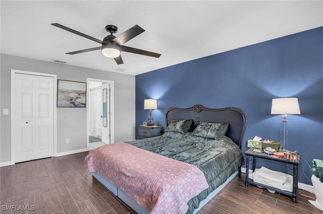 bedroom featuring ensuite bath, dark hardwood / wood-style floors, and ceiling fan