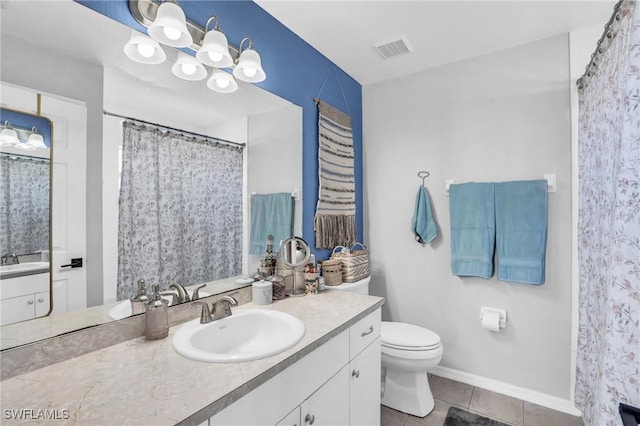 bathroom with an inviting chandelier, vanity, toilet, and tile patterned flooring