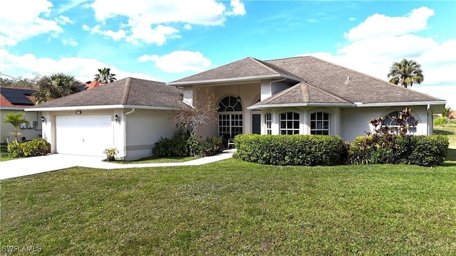 view of front of home with a garage and a front lawn