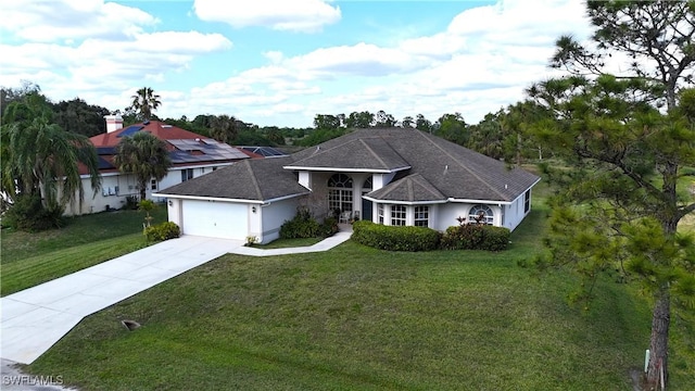 view of front of house with a garage and a front lawn