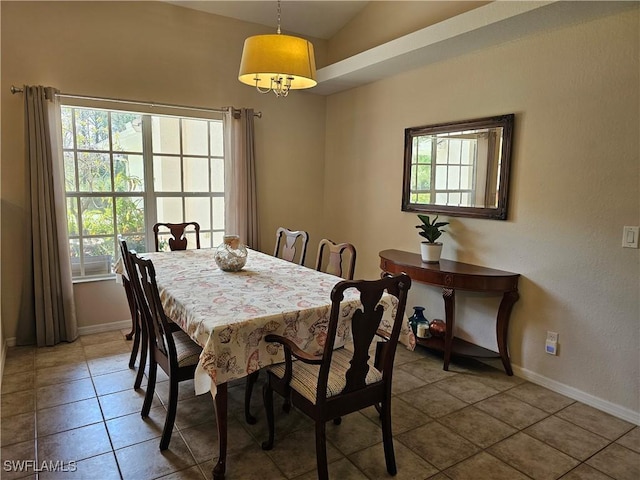 tiled dining room featuring lofted ceiling