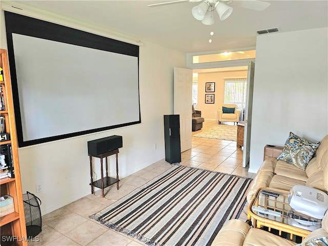 tiled cinema room featuring ceiling fan