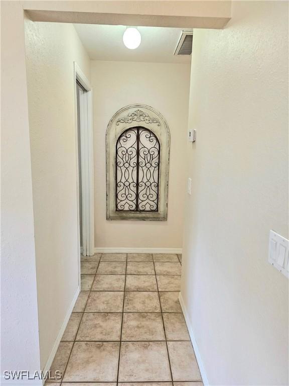 hall with light tile patterned flooring