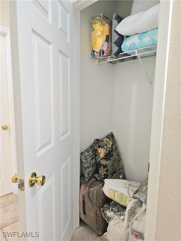 spacious closet featuring light tile patterned floors