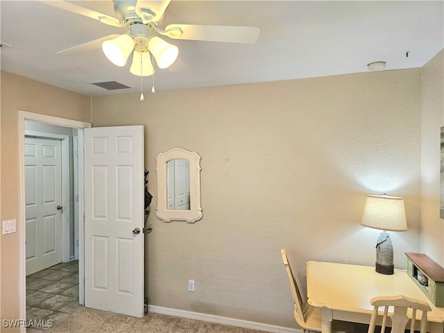 office with light carpet and ceiling fan