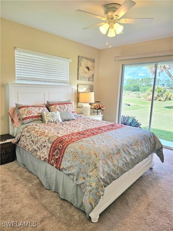 bedroom with access to exterior, ceiling fan, and carpet